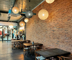 Inside Effronte — warm brick walls and wooden tables