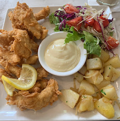 Crispy fried platter with potatoes and salad
